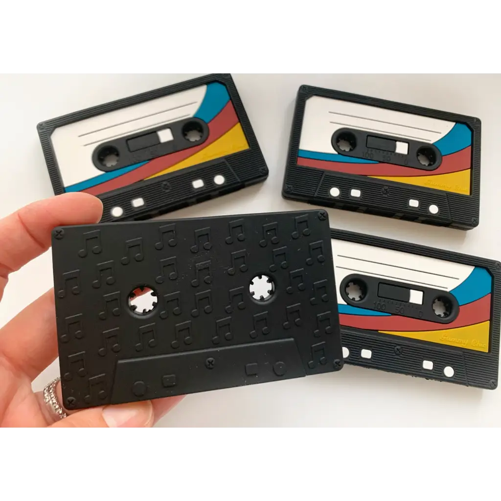 Black retro cassette tape teether with colorful stripes for baby’s teething relief