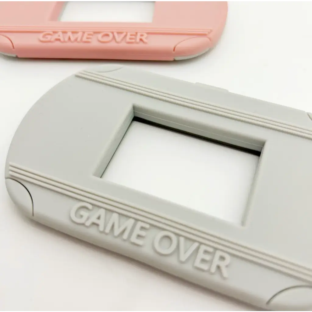 Gray plastic frame with GAME OVER text on Video Game Inspired Silicone Teether for babies