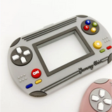 Gray handheld gaming device with colorful buttons for Video Game Inspired Silicone Teethers