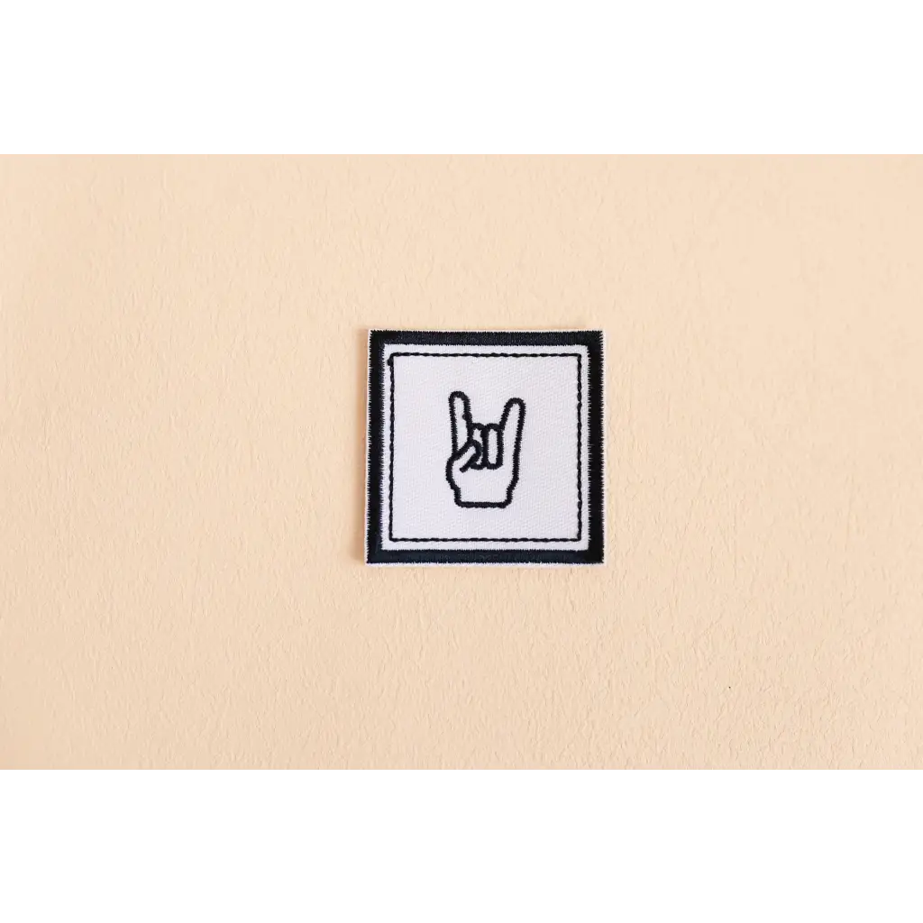 Playful Rock iron-on patch featuring a fun rock-and-roll devil horns hand gesture icon