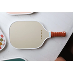 White pickle ball paddle with orange grip for fun Vintage-style Pickle Ball Game