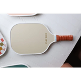 White pickle ball paddle with orange grip for fun Vintage-style Pickle Ball Game