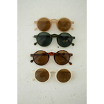 Adorable round sunglasses in cool brown and black tones for stylish kids’ summer looks