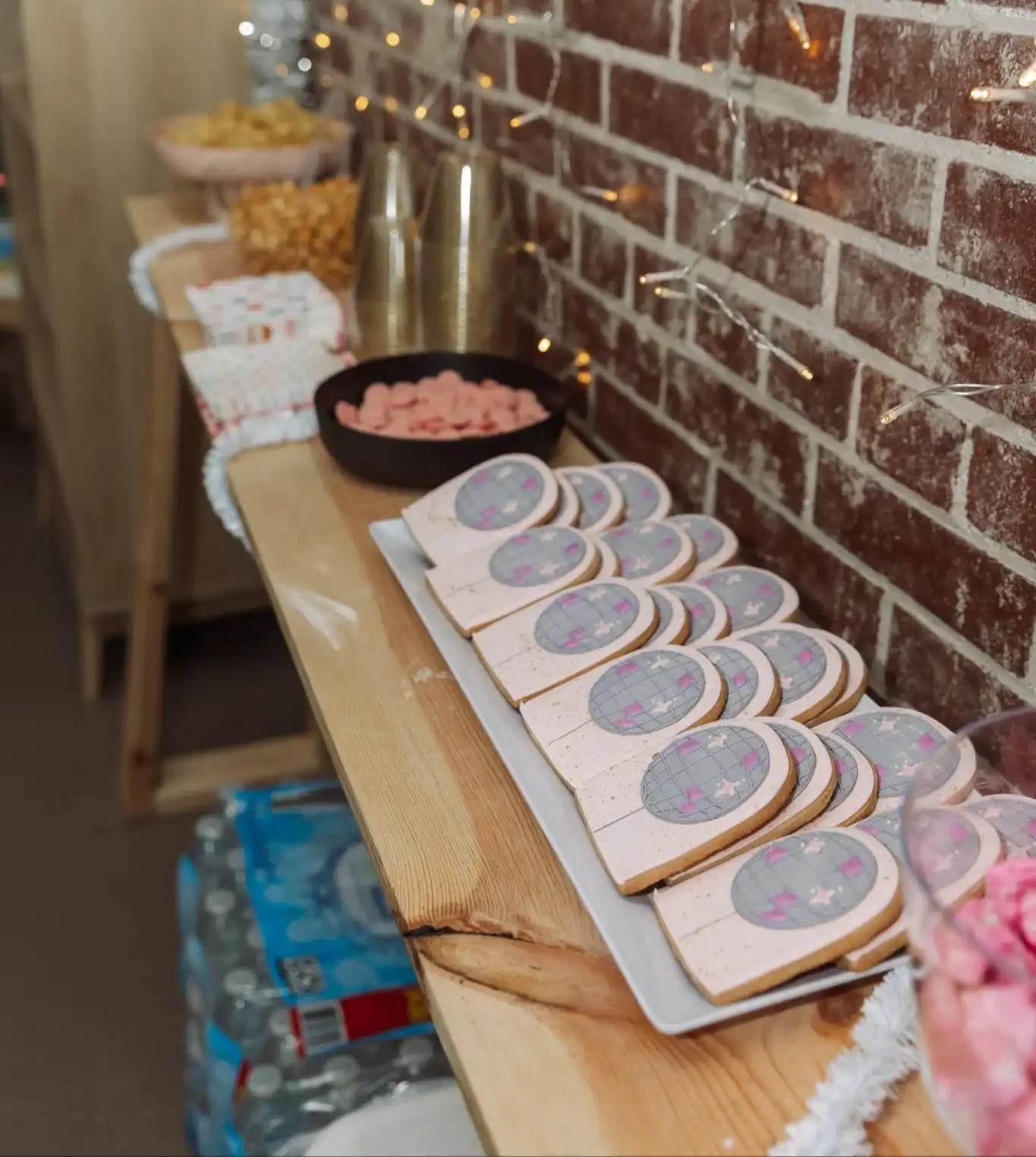 Row of decorated sugar cookies with a holographic or iridescent design on top.