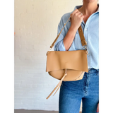 Tan leather Roxie Saddle Crossbody Bag, the perfect addition to stylish womens clothes