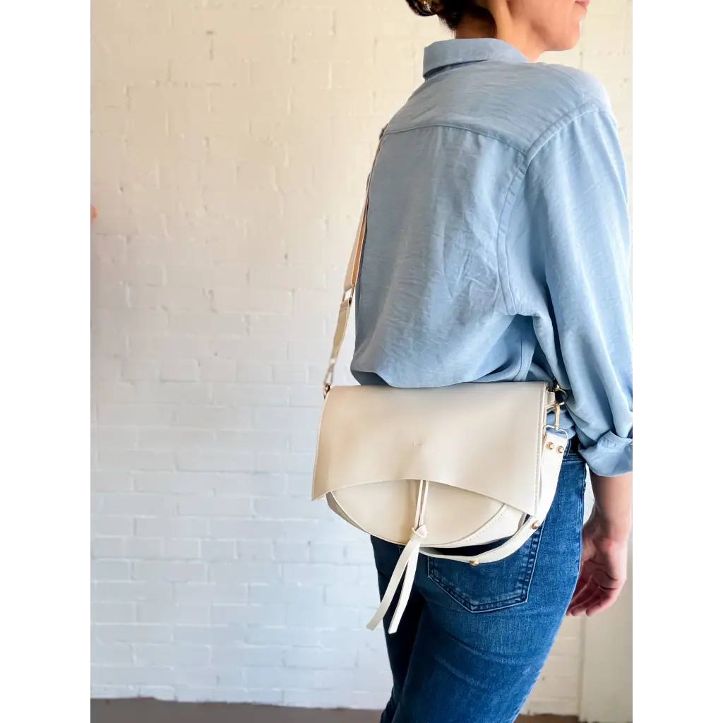 Stylish Roxie Saddle Crossbody Bag in white leather, perfect for polished prints