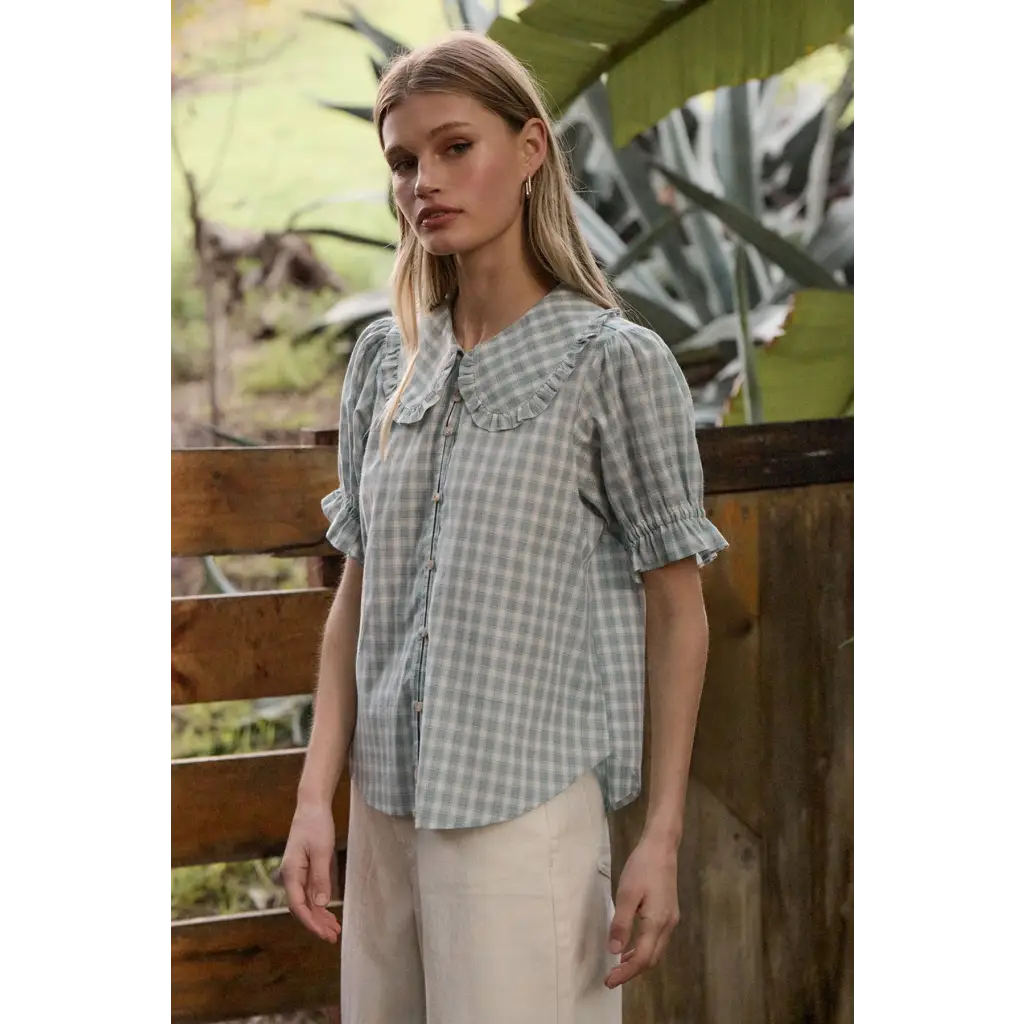 Light green gingham blouse with soft ruffle collar and puffed sleeves