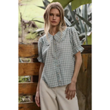 Light blue gingham blouse with soft ruffle collar and puffed sleeves