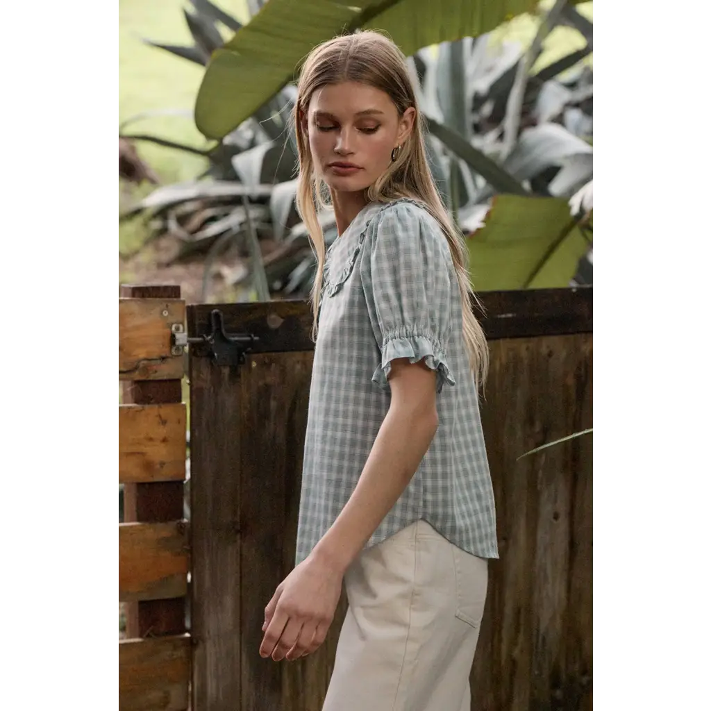 Light blue gingham blouse with soft ruffle collar and sleeves
