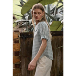 Light blue gingham blouse with soft ruffle collar and sleeves