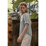 Light blue gingham blouse with soft ruffle collar and sleeves