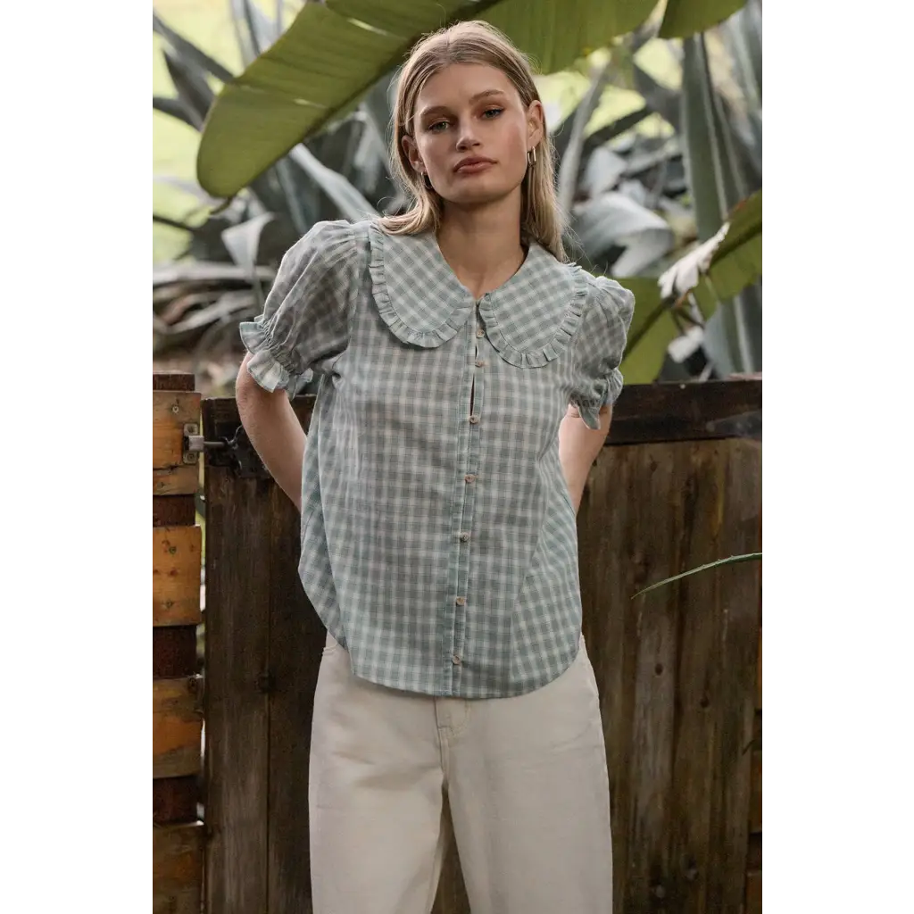 Light green gingham blouse with soft ruffle collar and puffed sleeves