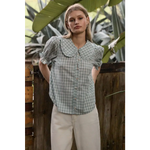 Light green gingham blouse with soft ruffle collar and puffed sleeves