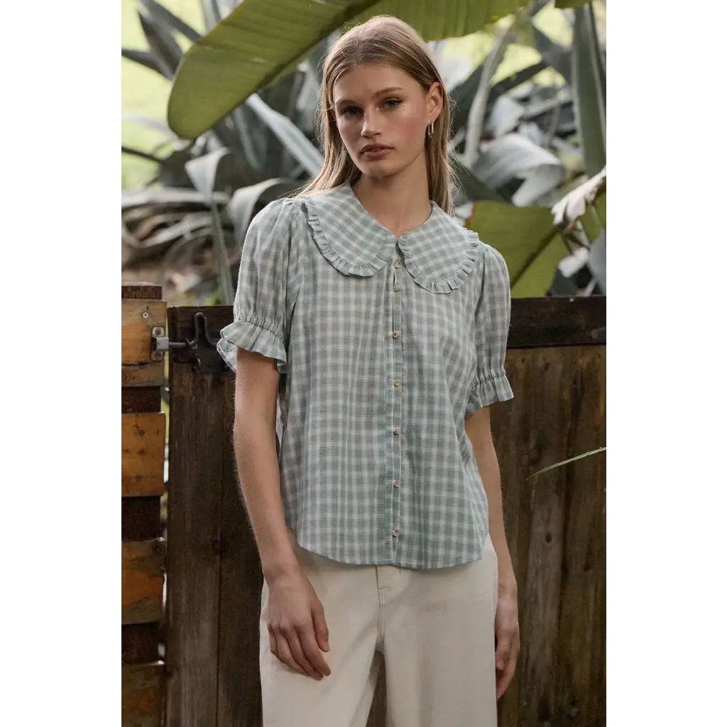 Light green gingham blouse with soft ruffle collar and puffed sleeves