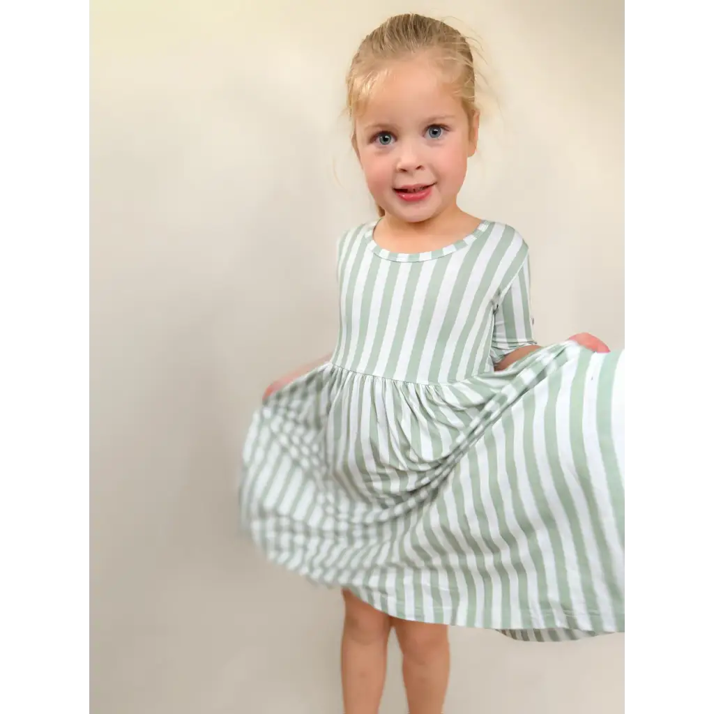 Sage green striped bamboo twirl dress for girls with long sleeves and ruffled hem