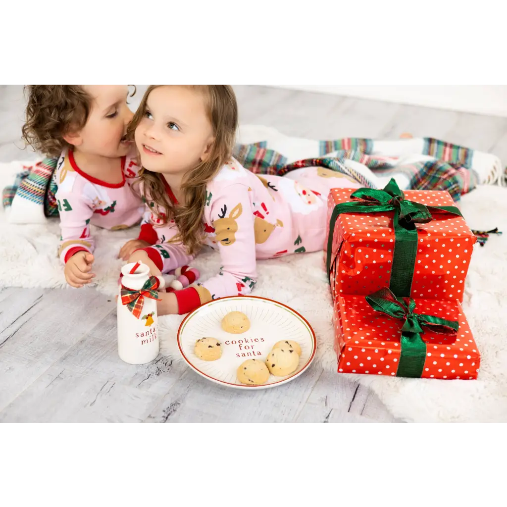Pink reindeer polka dot pajama set on Santa cookie plate