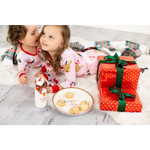 Pink reindeer polka dot pajama set on Santa cookie plate