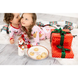 Pink reindeer polka dot pajama set on Santa cookie plate