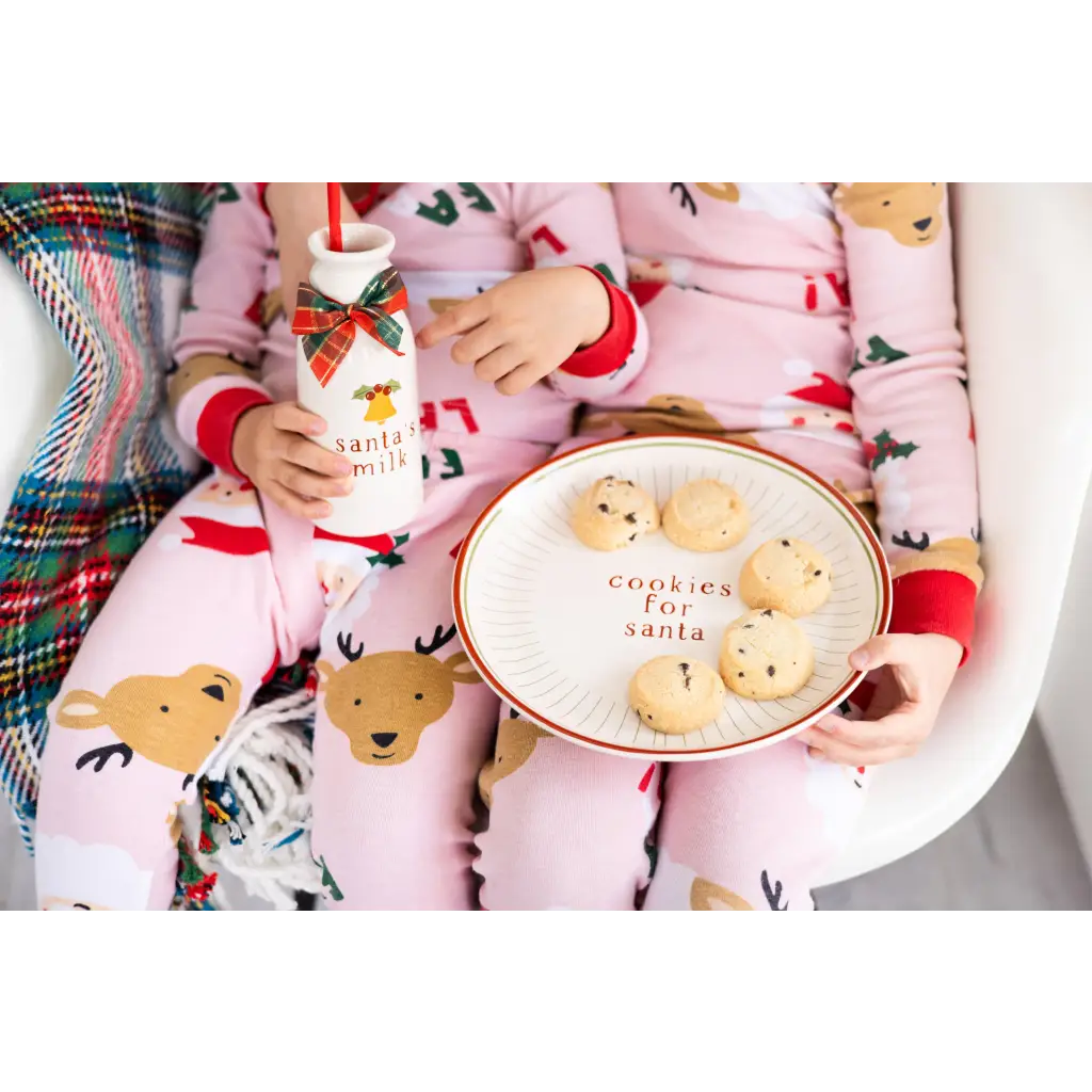 Pink reindeer cotton pajama set on Santa cookie plate display