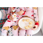 Pink reindeer cotton pajama set on Santa cookie plate display