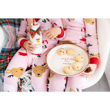 Pink reindeer cotton pajama set on Santa cookie plate display