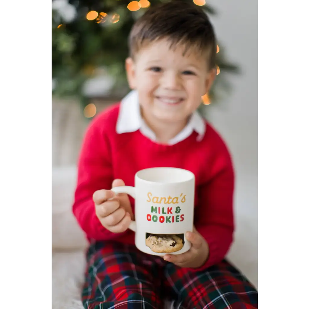 Santa’s Milk & Cookies mug with festive red green design, white handle