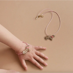 Delicate gold-toned butterfly bracelet with pink accents in a lovely gift box