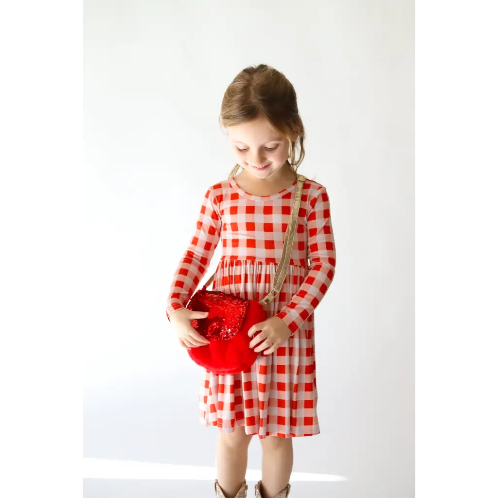 Red and white checkered dress paired with a sequin velvet bag and matching purse