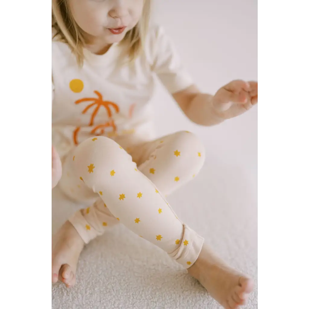 White pajama set with orange palm trees and yellow polka dots for Bright Star Leggings