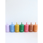 Seven colorful silicone straw cups with straws in a rainbow sequence for fun sips