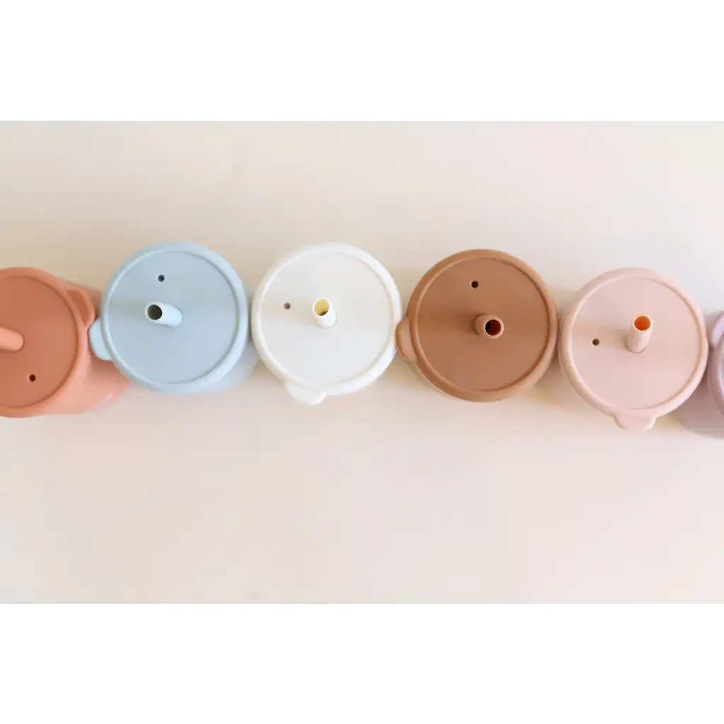 Row of pastel circular lids for Mini Silicone Straw Cups, perfect for kids’ drinks