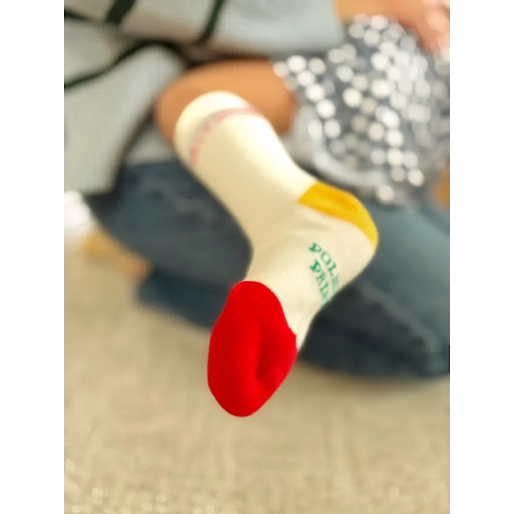 Red and white Silly Goose toddler socks with green text on gray background