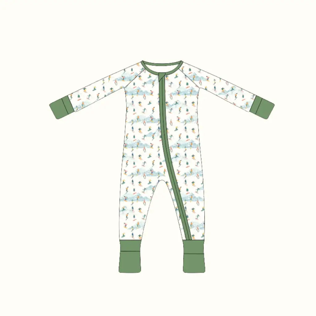 Cute bamboo baby sleeper with white onesie, green trim, and playful ski pattern