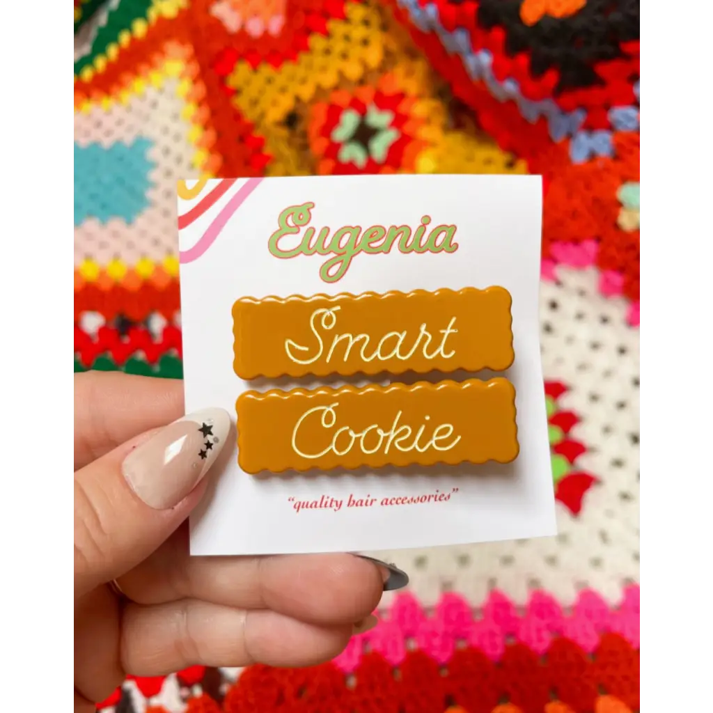 Gold smart cookie hair clips on a white Eugenia card for a fun look