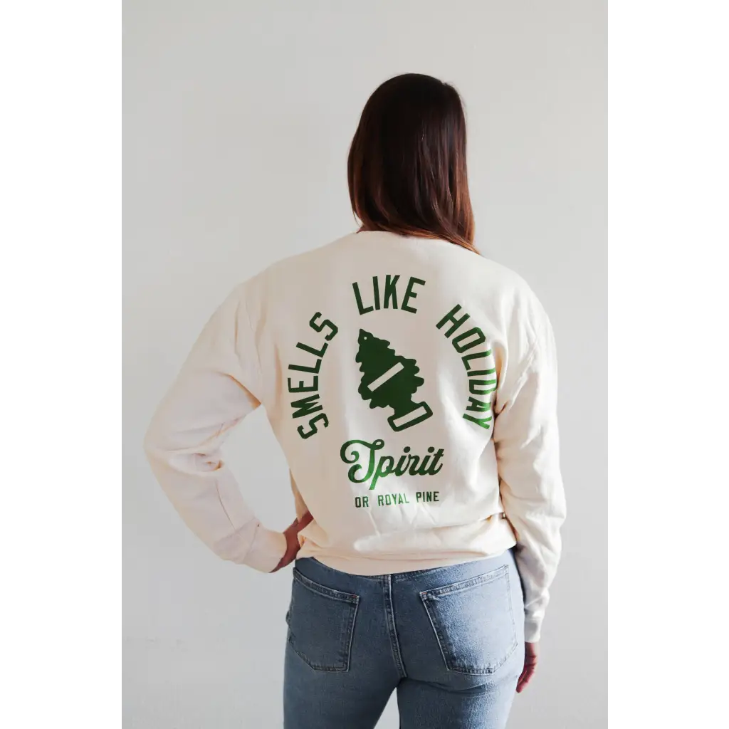 White lightweight pullover with green Smells Like Holiday Spirit text and pine tree graphic