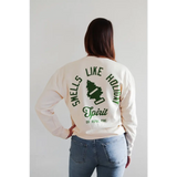 White lightweight pullover with green Smells Like Holiday Spirit text and pine tree graphic