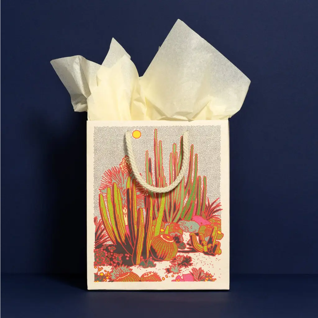Cactus gift bag with white tissue paper, vibrant desert colors, stylish womens clothes vibe