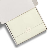 Cream-colored business card holder with silver accents from Soft White tissue paper for stylish womens clothes