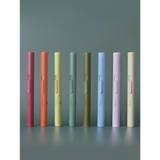 Eight pastel-colored pens beside a solid flameless rechargeable lighter for clean igniting