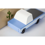 Light blue Sonora Pickup Toy car with white cargo for fun at Lone Cactus Motel