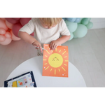 Orange paper with a smiling sun drawing for Space Scissor Skills Activity Kit