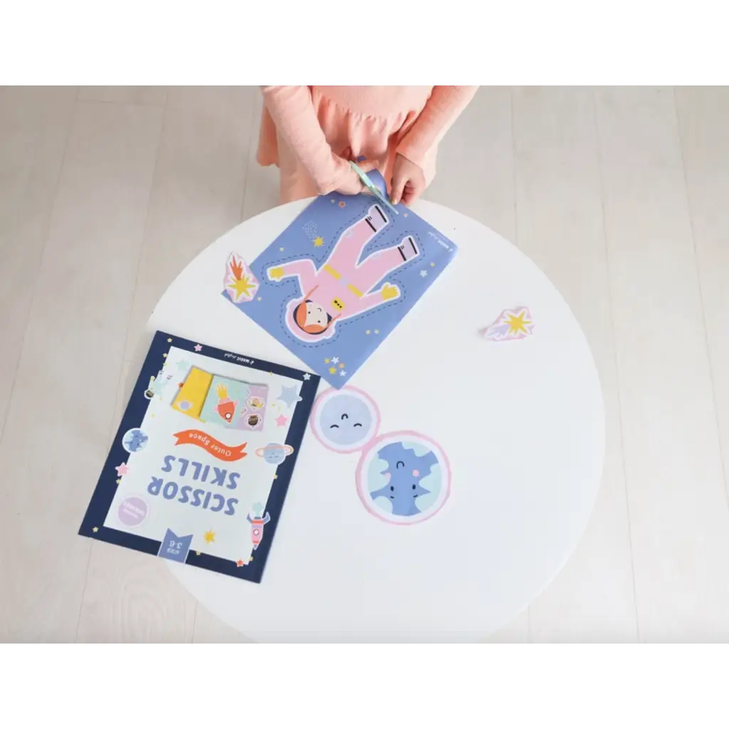 Hands arranging colorful cards for the Space Scissor Skills Activity Kit