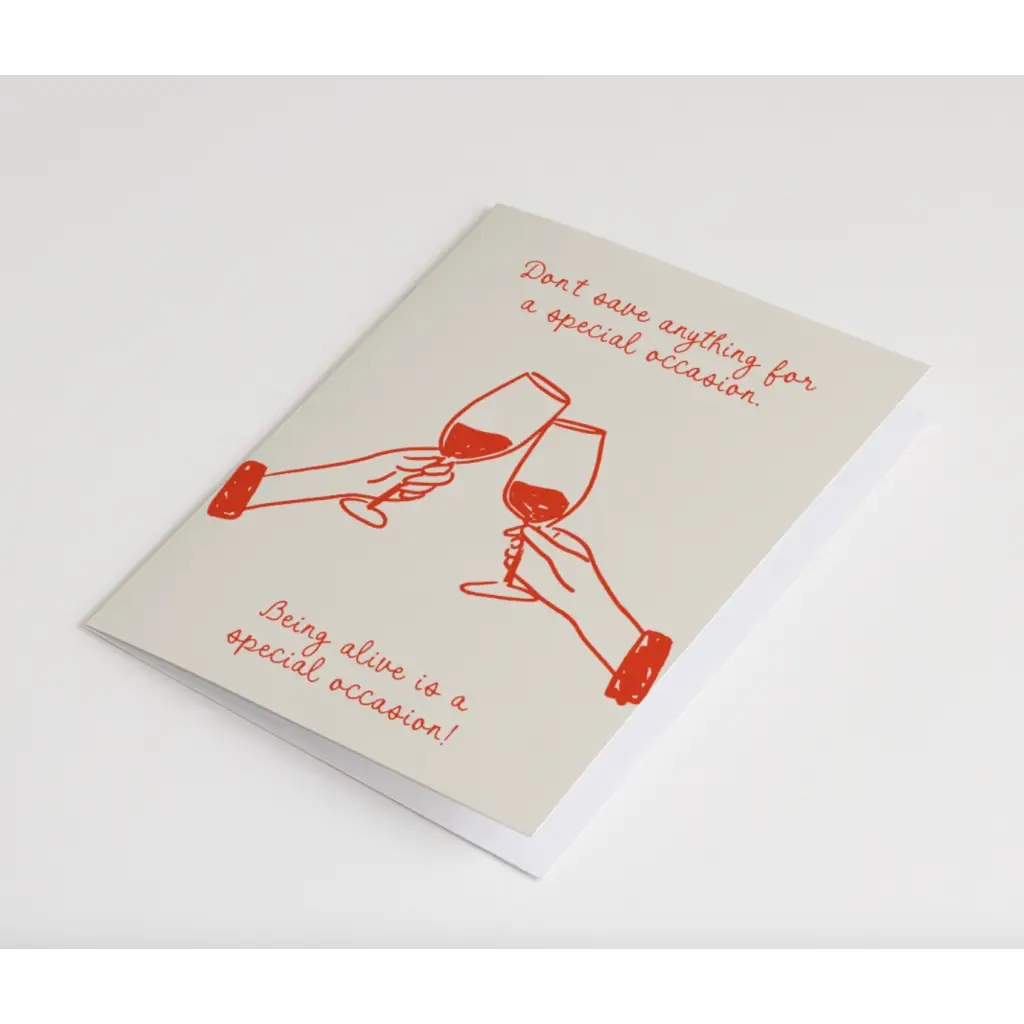 Simple red line drawing of hands clinking glasses on a Special Occasion Card, blank inside