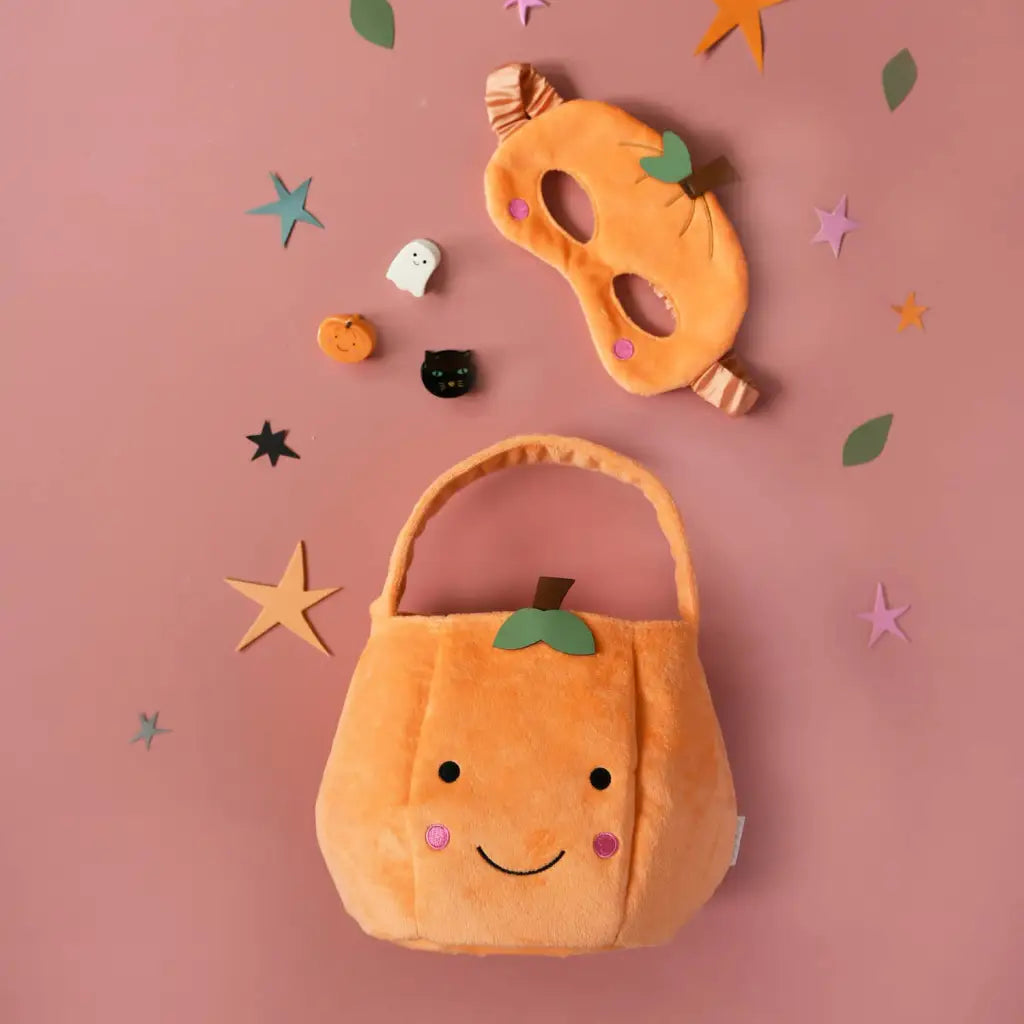 Plush pumpkin-shaped Halloween trick-or-treat bag with a happy face for stylish womens clothes