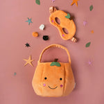 Plush pumpkin-shaped Halloween trick-or-treat bag with a happy face for stylish womens clothes