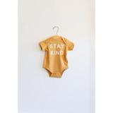 Stay Kind Organic Baby Onesie in yellow made from soft organic cotton fabric