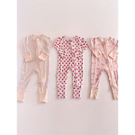 Three pink bamboo baby sleepers with dot and bow prints