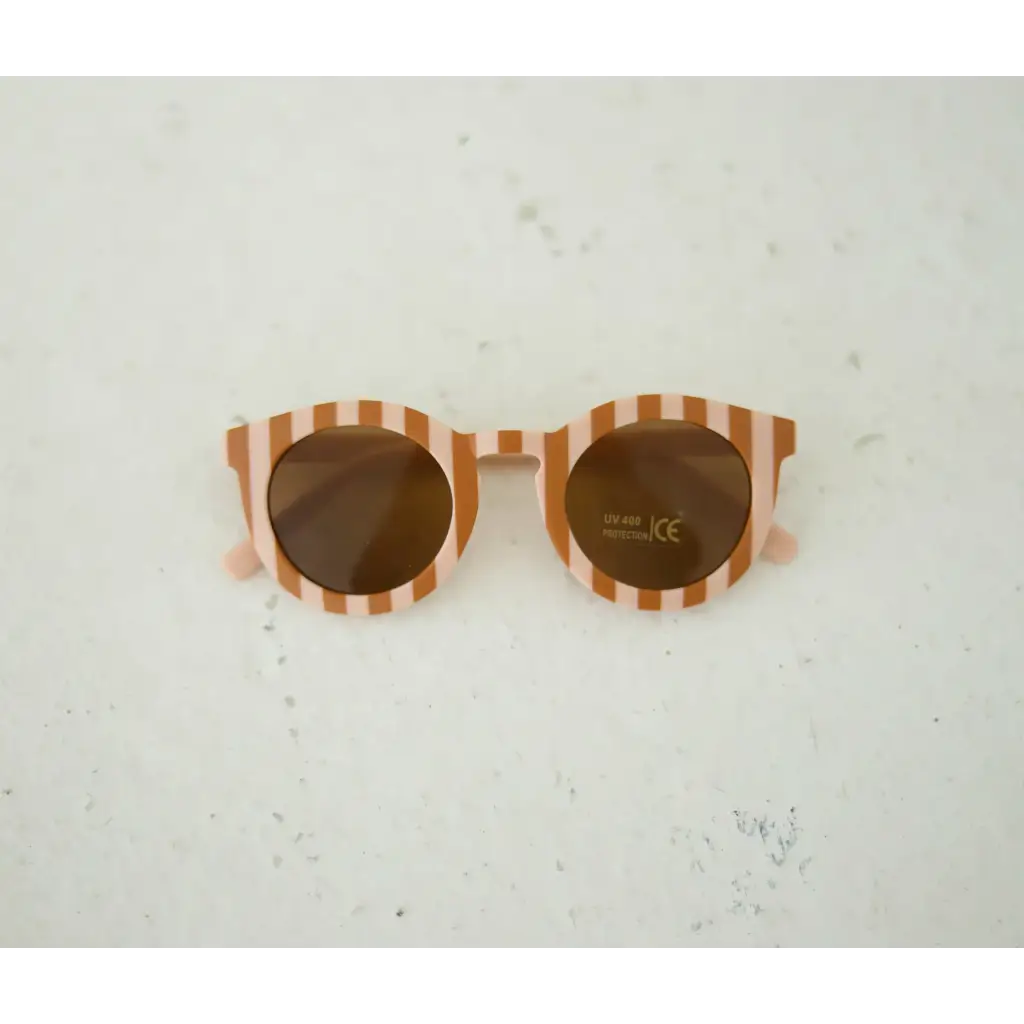 Round striped baby sunnies with orange and white frames to show off one’s style