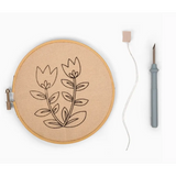 Embroidery hoop with floral punch needle design from Summer Tulips Punch Needle Kit