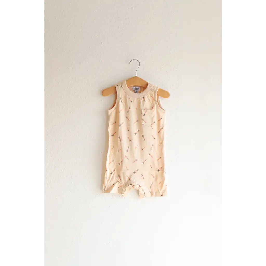 Sleeveless beige pocket playsuit with floral print for the ultimate summer vibe